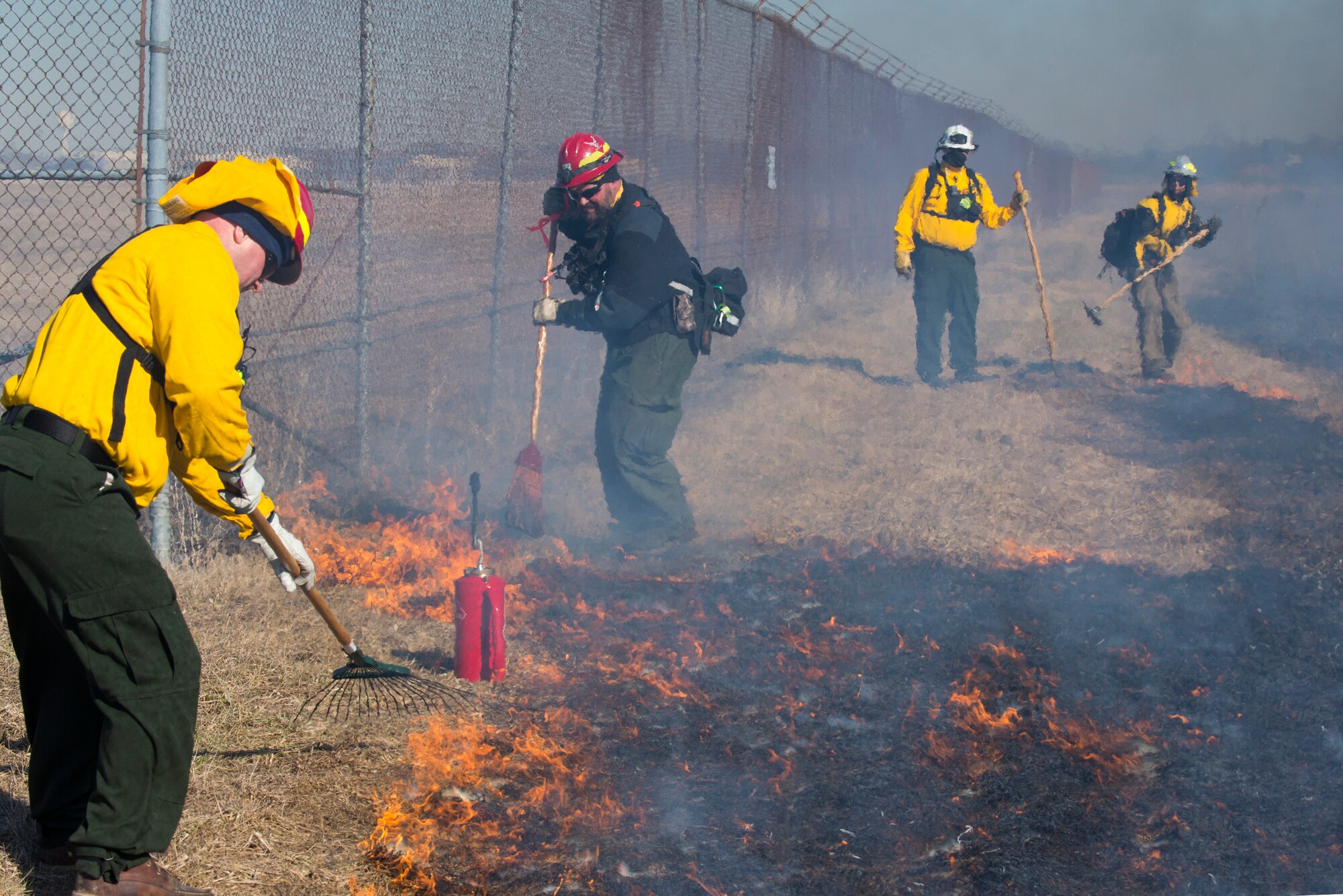 Darryn Warner, 88th Civil Engineering Group Natural Resource Program manager, and District Chief Matt Dickey, Wright-Patterson Air Force Base, Ohio, Fire Department, part of the 788th Civil Engineer Squadron, stop a prescribed burn on Huffman Prairie from spreading on to the base Feb, 21, 2020. Prairie grass is a warm-season grass species and benefits from being burned. (U.S. Air Force photo/R.J. Oriez)
