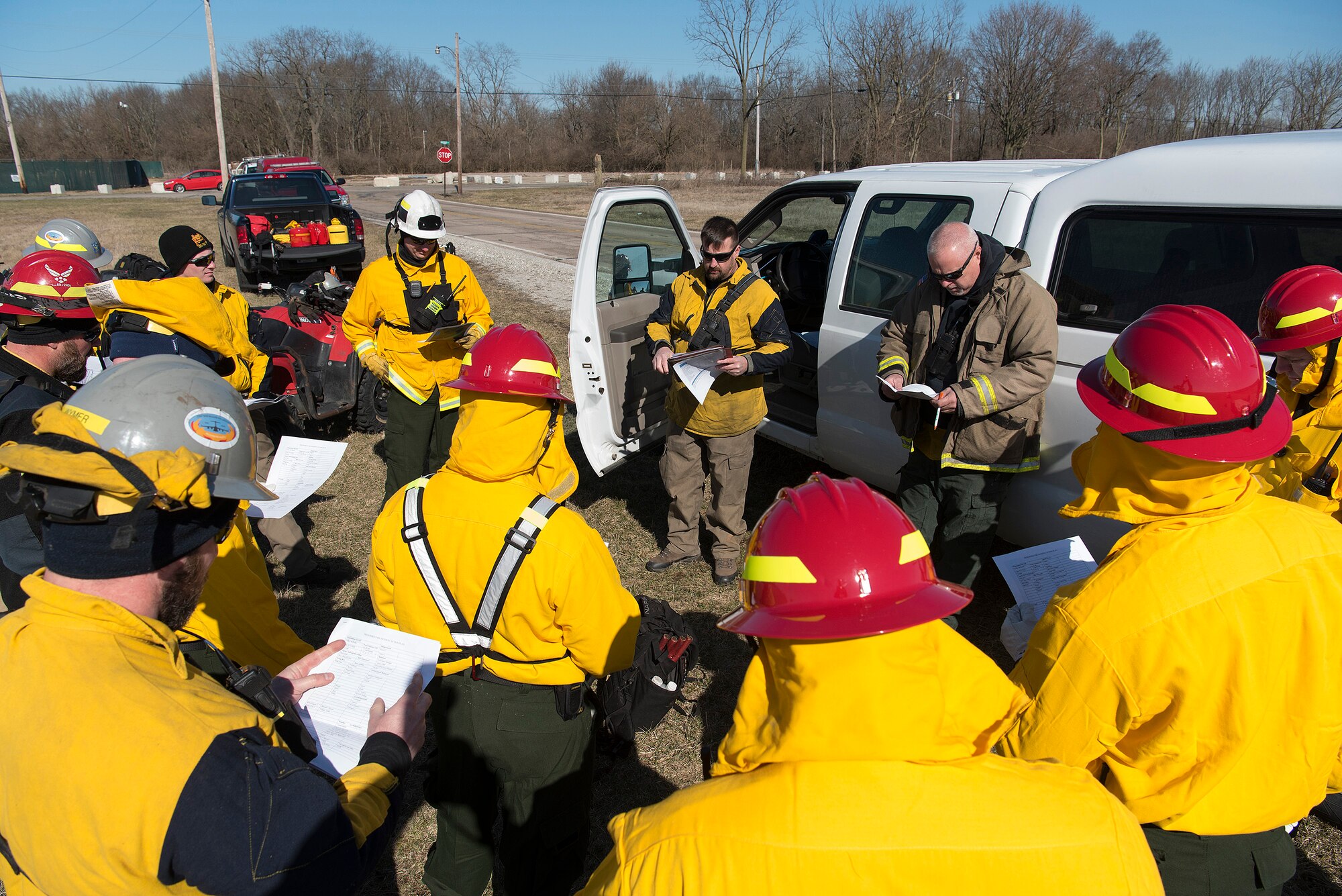Members of the Air Force Wildland Fire Branch Wildland Support Module and the Wright-Patterson Air Force Base, Ohio, Fire Department, part of the 788th Civil Engineer Squadron, are briefed Feb. 21, 2020, prior to the setting of a prescribed burn on a plot of land just north of the base. The wildland support module, out of Joint Base McGuire-Dix-Lakehurst, N.J., travels the Eastern United States setting prescribed fires mostly with the goal of reduce hazardous fuel levels to minimize the threat of brush and forest fires to Air Force installations and personnel.  (U.S. Air Force photo/R.J. Oriez)