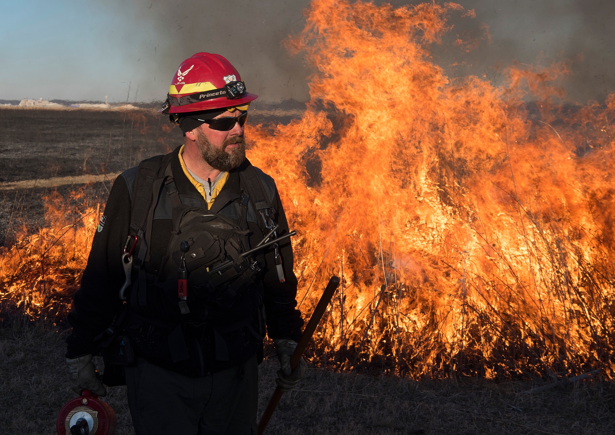 Darryn Warner, 88th Civil Engineering Group Natural Resource Program manager, stands in front of a prescribed burn on Huffman Prairie Feb. 21, 2020. Warner coordinated and oversaw the burn which was used to help the native prairie grass grow. (U.S. Air Force photo/R.J. Oriez)