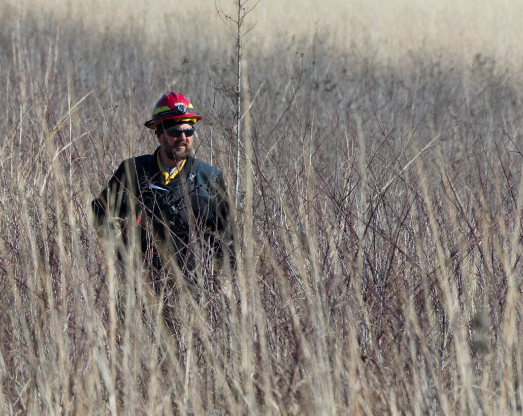 Darryn Warner, 88th Civil Engineering Group Natural Resource Program manager, walks through the grass on Huffman Prairie Feb. 21, 2020, prior to setting it on fire. The 50-acre plot of land, just outside of Wright-Patterson Air Force Base, Ohio, was burned to help the natural prairie grass grow and to discourage woody vegetation. (U.S. Air Force photo/R.J. Oriez)