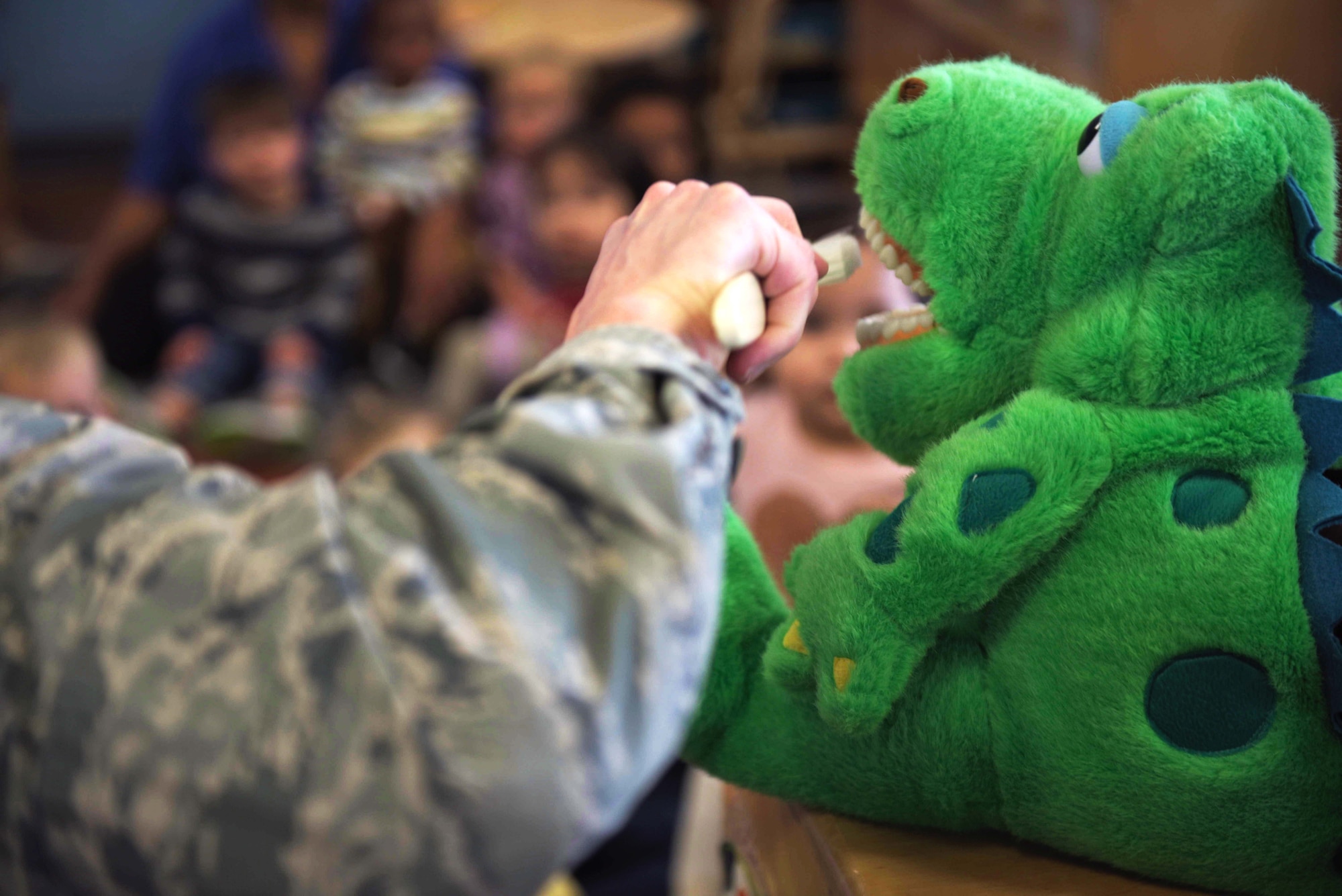 U.S. Air Force Maj. Nicholas Einbender, 325th Medical Group dentist, pretends to brush the teeth of a puppet during a dental demonstration at Tyndall Air Force Base, Florida, Feb. 27, 2020. February is National Children's Dental Health Month, and the 325th MDG's dental team reached out to the 325th Force Support Squadron's Child and Youth Program Center (formerly known as the Child Development Center) to teach young children the importance of brushing and flossing teeth. (U.S. Air Force photo by Staff Sgt. Magen M. Reeves)
