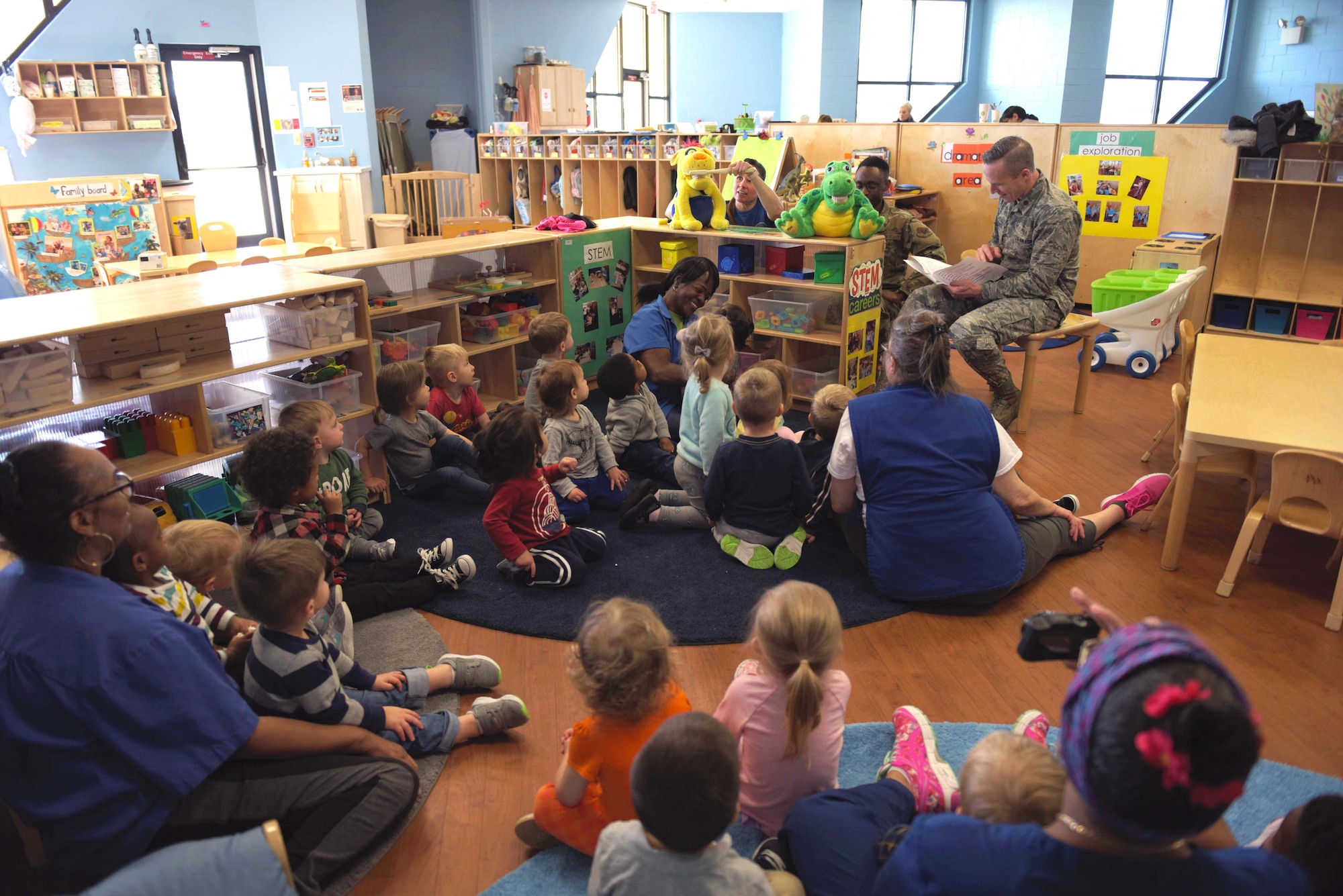 Lori Elliot, 325th Medical Group civilian personnel (left), U.S. Air Force Staff Sgt. Myron Little, 325th MDG noncommissioned office in charge of dental logistics (center), and U.S. Air Force Maj. Nicholas Einbender, 325th Medical Group dentist, perform a demonstration using puppets to children at Tyndall Air Force Base, Florida, Feb. 27, 2020. February is National Children's Dental Health Month, and the 325th MDG's dental team reached out to the 325th Force Support Squadron's Child and Youth Program Center (formerly known as the Child Development Center) to teach young children the importance of brushing and flossing teeth. (U.S. Air Force photo by Staff Sgt. Magen M. Reeves)