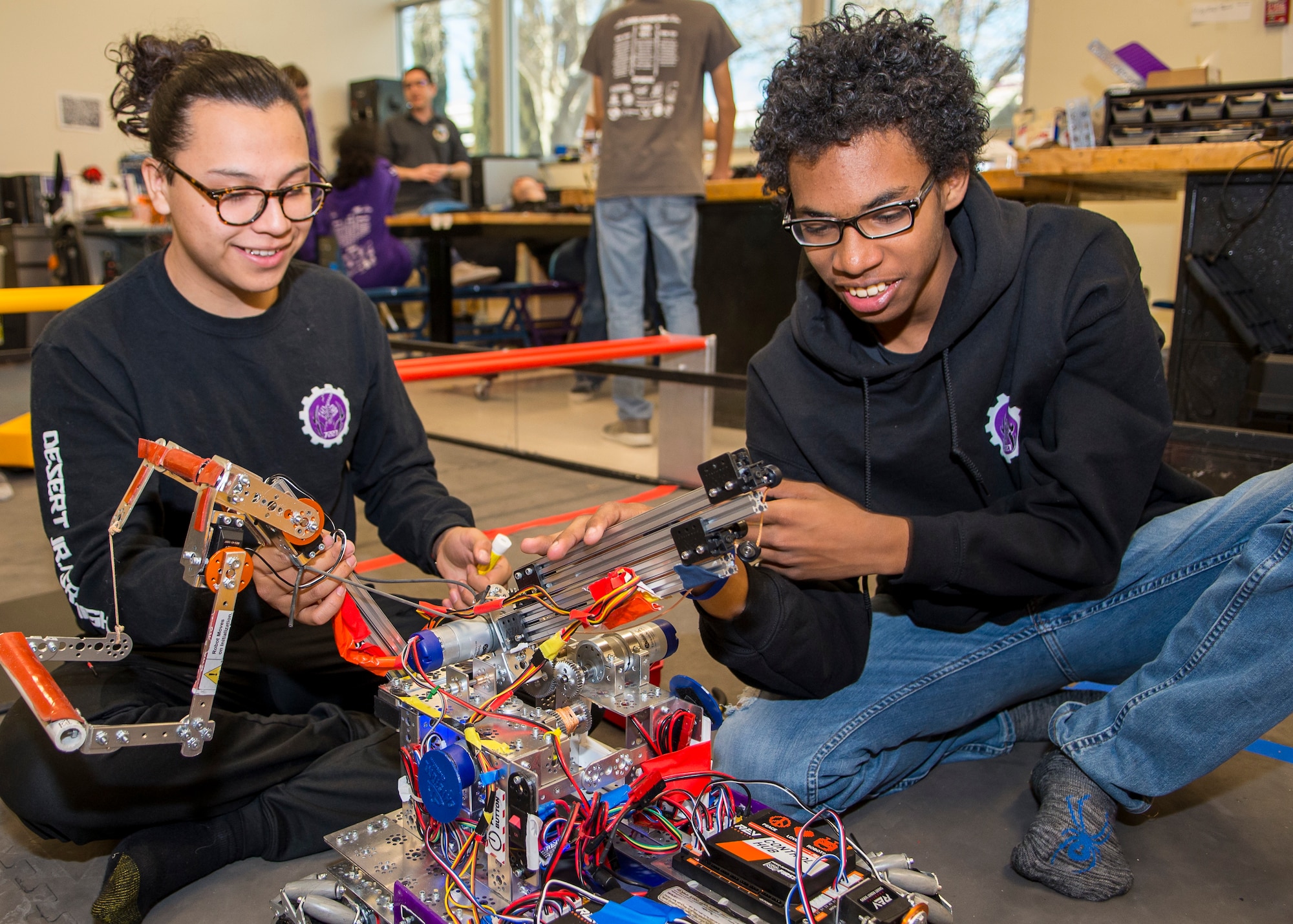 Scorpion Robotics Club Team 7227 members Juan Carlos Garcia and Eloy Fernandez work on improving their robot at Desert Junior-Senior High School on Edwards Air Force Base, California, Feb. 12. (Air Force photo by Giancarlo Casem)