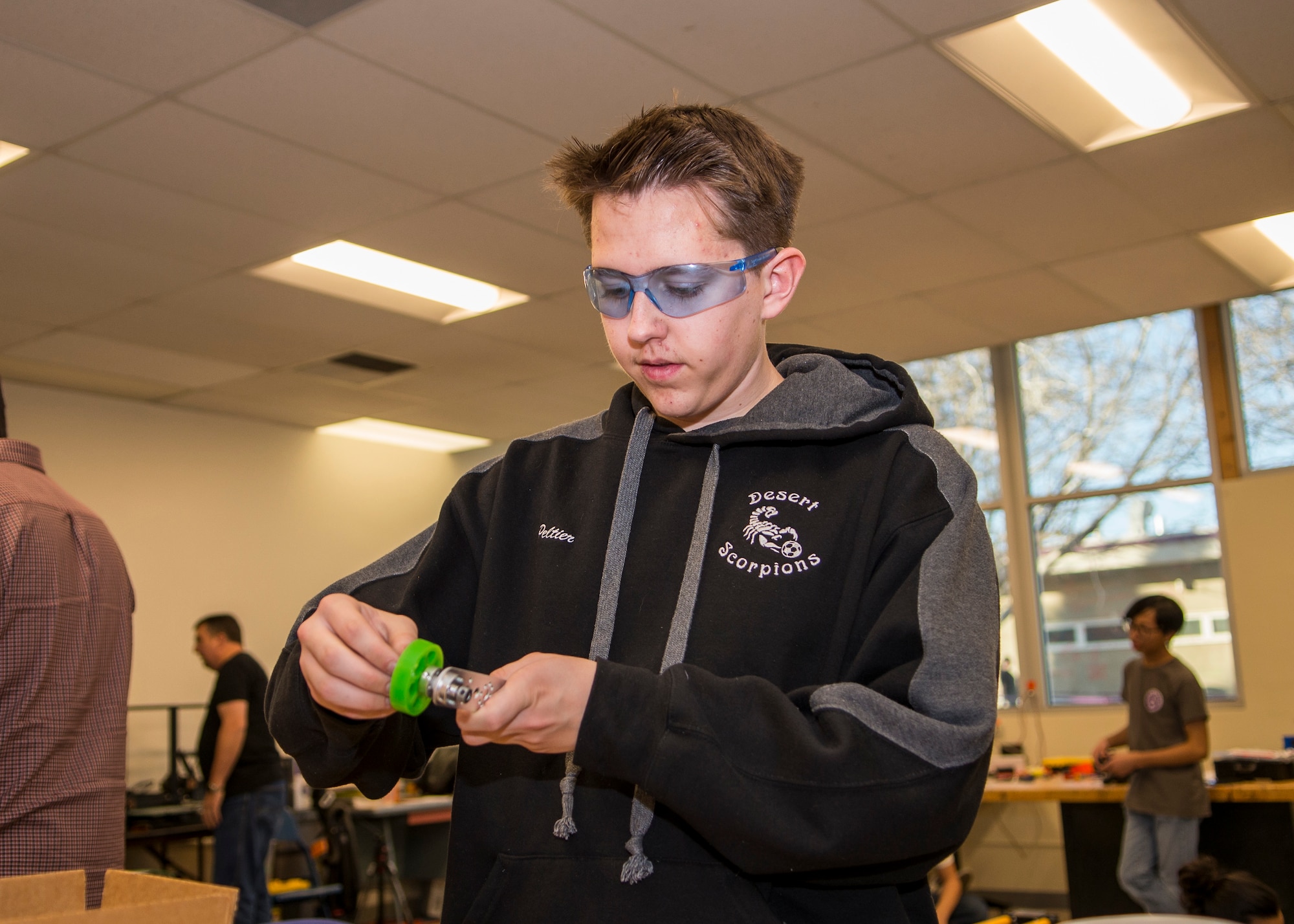 Scorpion Robotics Club Team 7227 member, Aiden Peltier, works on an improved arm mechanism for his team’s robot at Desert Junior-Senior High School on Edwards Air Force Base, California, Feb. 12. (Air Force photo by Giancarlo Casem)