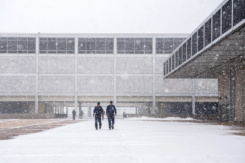 Cadets cross the terrazzo braving winter weather