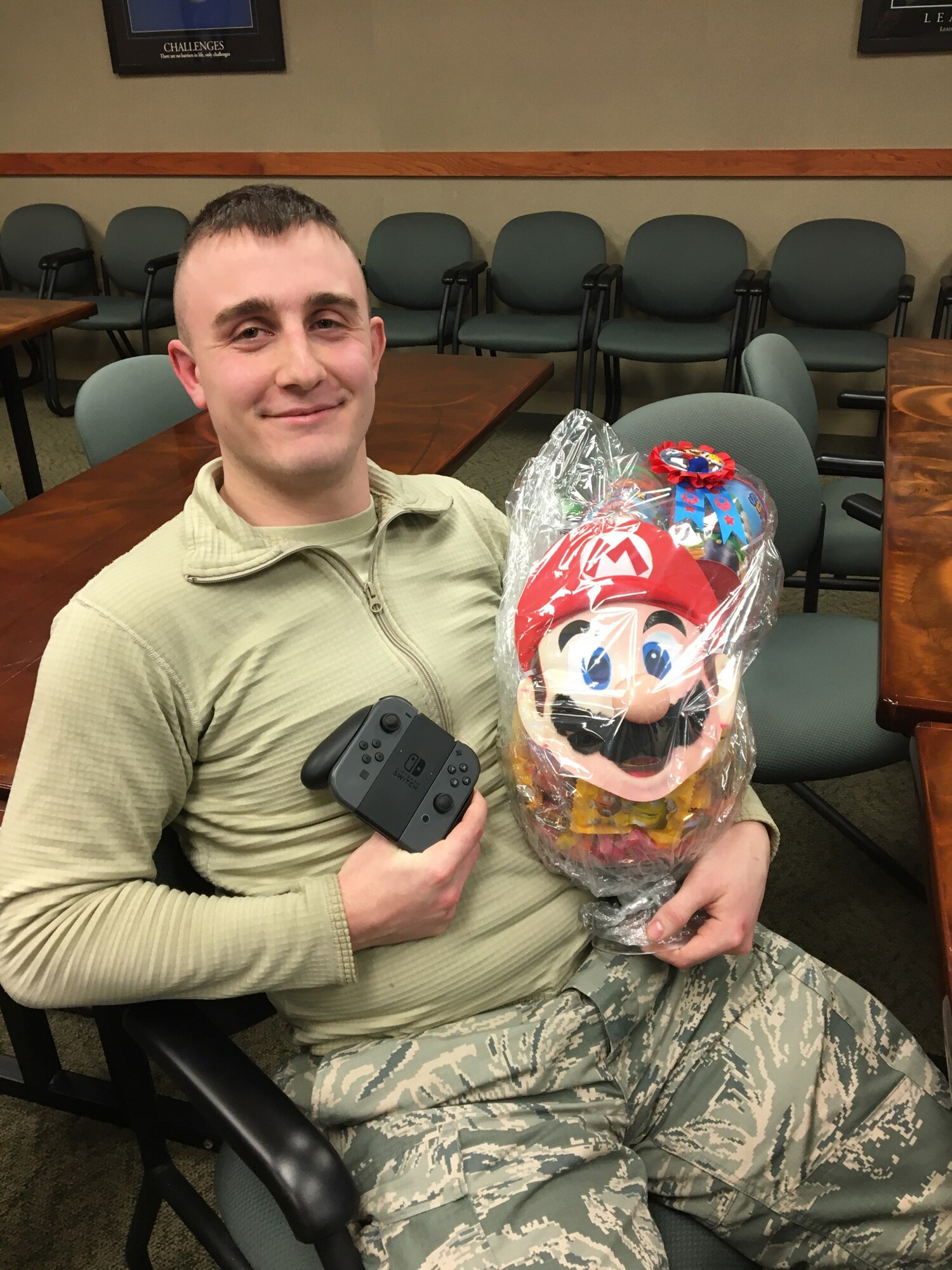 Staff Sgt. David Hannah, 434th Civil Engineering Squadron electrical systems apprentice, displays the prize he won for winning the Super Smash Bros. tournament held by Airman & Family Readiness, Feb. 8, 2020. Master Sgt. Hansel Orozco, 434th Air Refueling Wing religious affairs superintendent, organized the tournament as part of his second game night event, and the prize was provided by Master Sgt. Lisa Hendricks, 434th Aerospace Medicine Squadron medical service technician.