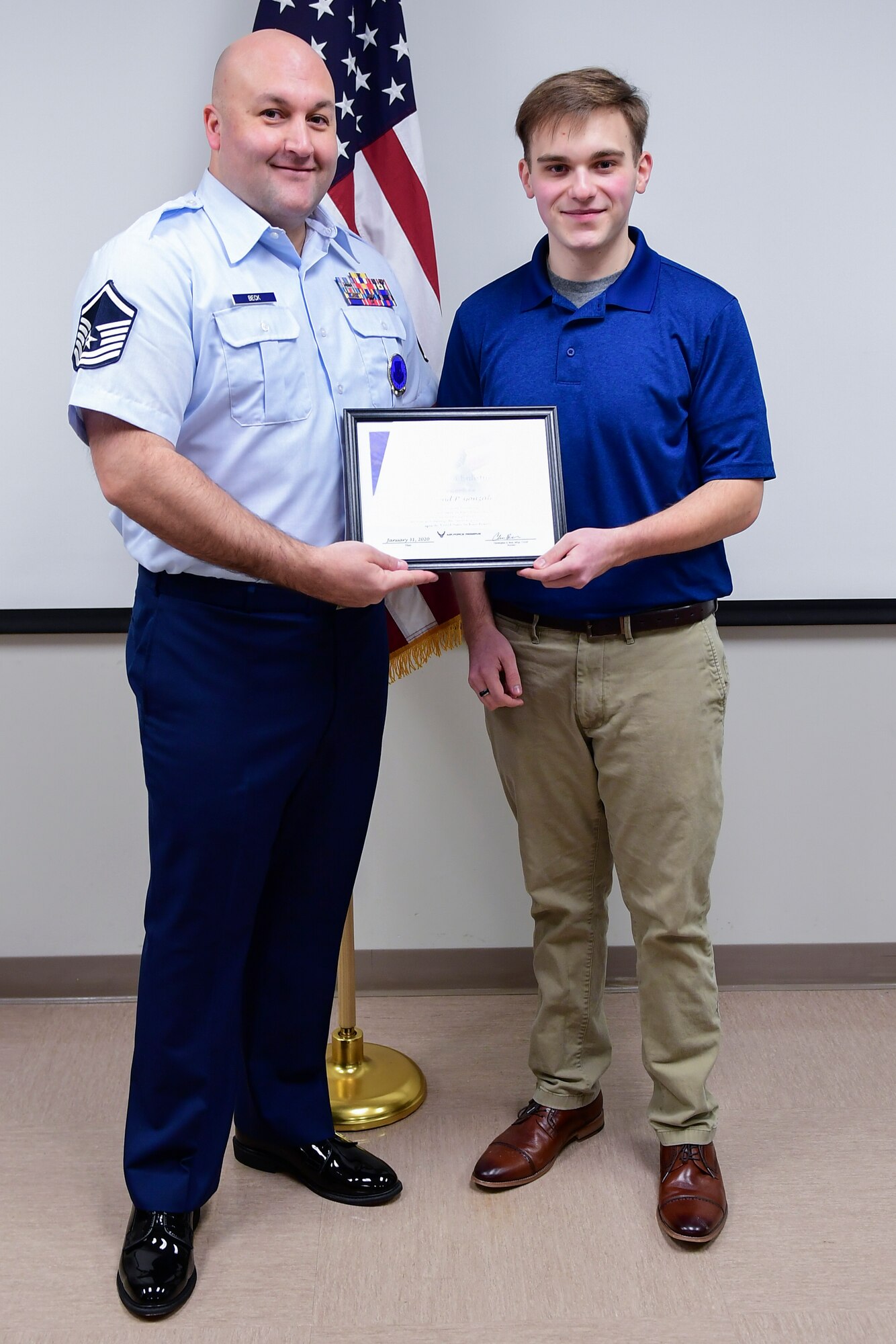 Raymond Gonzalez receives a certificate from Master Sgt. Christopher Beck, recruiter with the 911th Airlift Wing at the Pittsburgh International Airport Air Reserve Station, Pennsylvania, Jan. 31, 2020.