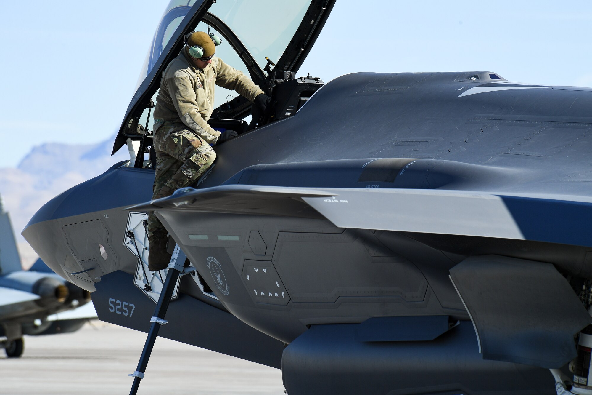 A photo of an F-35A maintainer working on the aircraft.