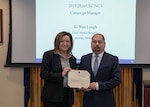 woman presents man with a certificate of appreciation during the 2019 CFC Closing Ceremony.