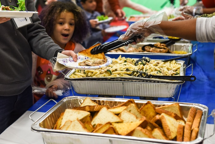 Airabella Jones, “Little Hero”, smiles while dinner was served at Joint Base Charleston, S.C., Feb. 27, 2020.