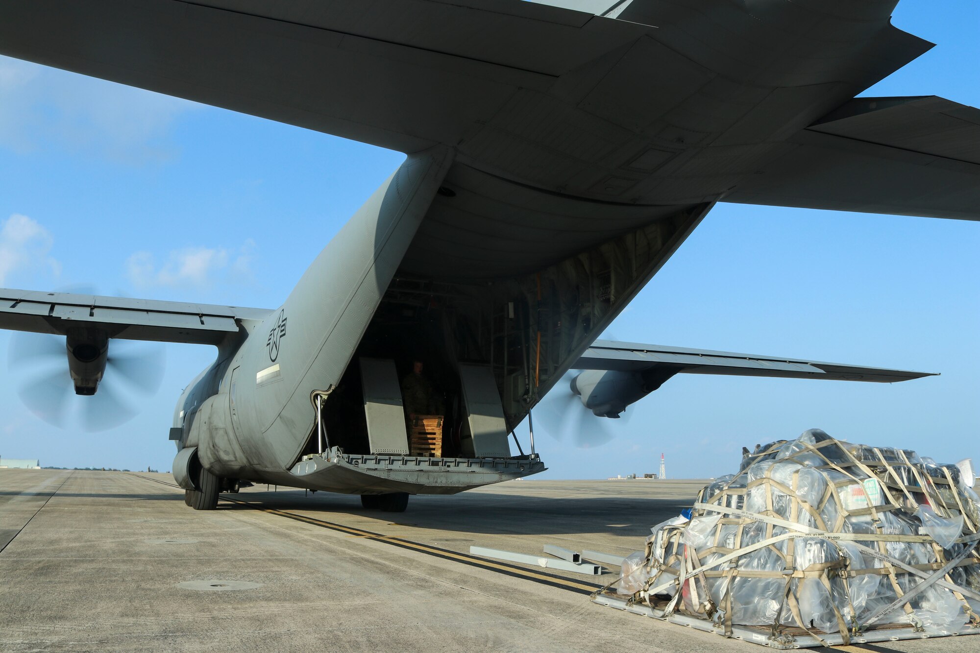 A C-130J Super Hercules aircraft moves down the flight line after service members complete combat offload training during an Agile Combat Employment experiment at Marine Corps Air Station Futenma.