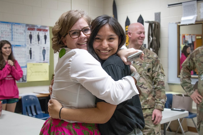 Ms. Catherine Pope (left), assistant principal at Prince George High School, hugs Future Soldier Emily Guzman Morales (right) after Guzman recited her Oath of Enlistment Feb. 26, 2020 at Prince George High School