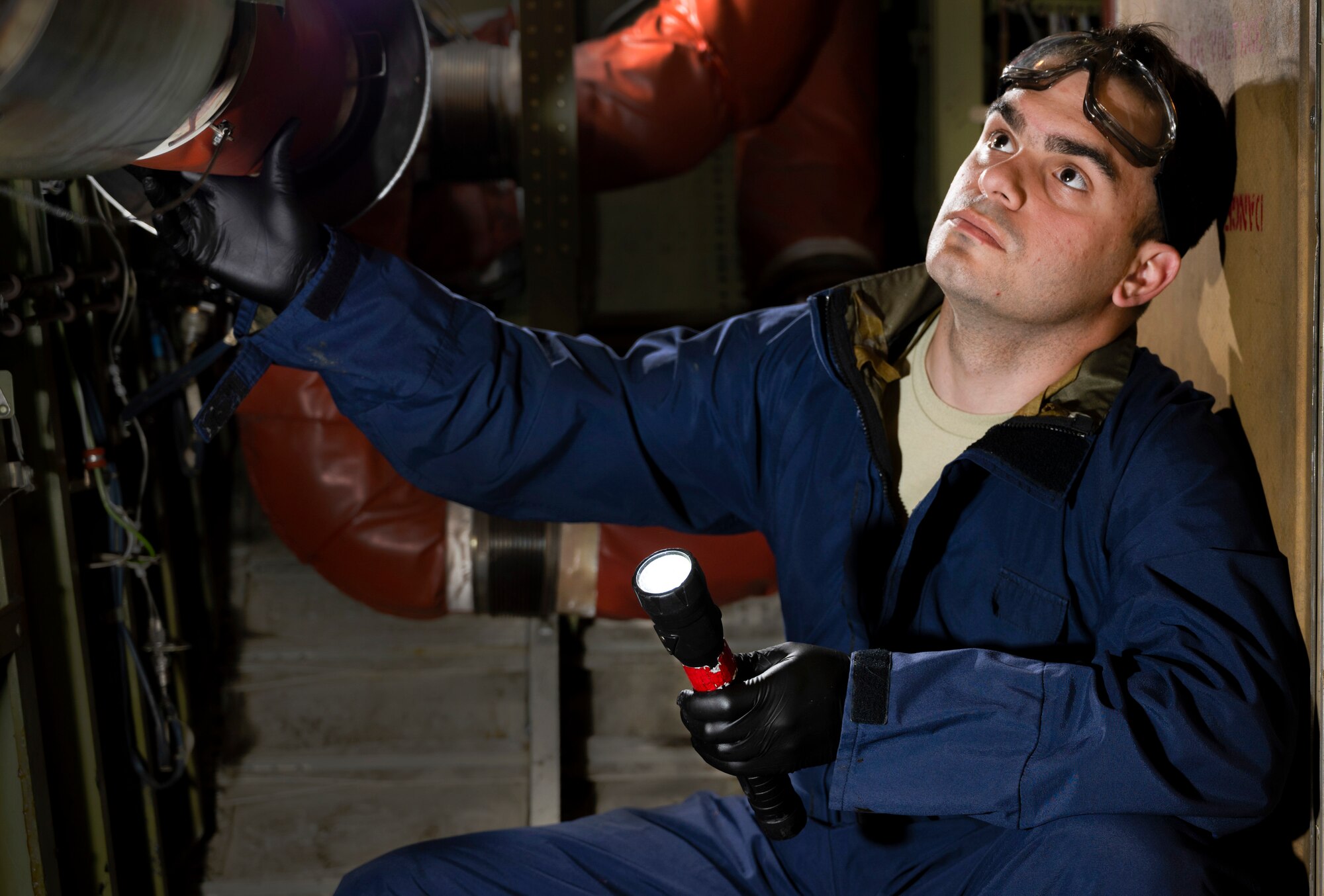 An Airman is using a flash light to inspect fuel cells inside a KC-10 Extender fuselage. fuselage Feb. 25, 2020, at Travis Air Force Base, California. Ramirez-Vazquez is this week’s Warrior of the Week, a program that recognizes Airmen who have made significant contributions to their units.