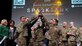 group of Airmen hold up trophy
