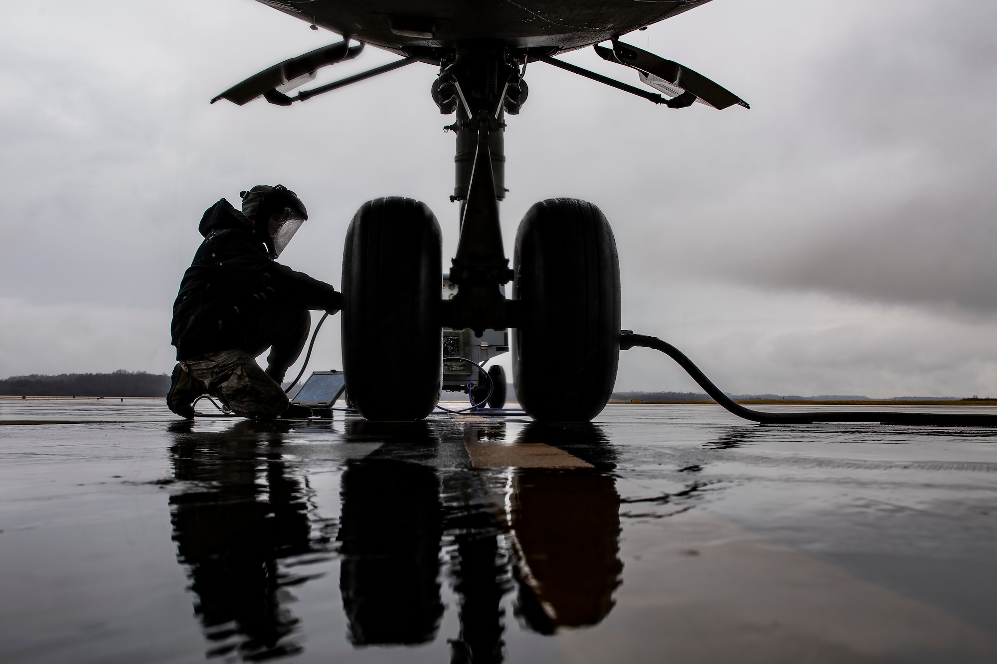 Crew chief services a nose landing-gear tire on a C-17 Globemaster III