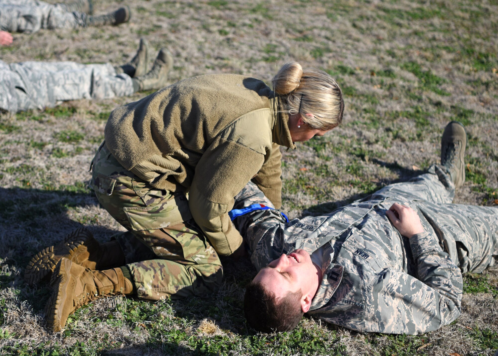 U.S. Air Force Capt. Melissa Seibert, 17th Operational Medical Readiness Squadron dentist, applies a tourniquet to Capt. Matthew Bean, 17th OMRS dentist, during the Tactical Combat Casualty Care course at Goodfellow Air Force Base, Texas, Feb. 21, 2020. TCCC is used to quickly treat wounds in combat situations. (U.S. Air Force photo by Airman 1st Class Ethan Sherwood)