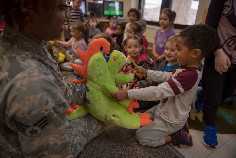 Senior Airman Bria Lipkins, 49th Operational Readiness Medical Squadron dental technician, allows a child to test his brushing techniques on a stuffed animal, Feb 11, 2020, on Holloman Air Force Base, N.M. The dental flight visits children across base annually, as part of Children’s Dental Health Month, to educate them and their caregivers on the importance of dental hygiene. (U.S. Air Force photo by Staff Sgt. Christine Groening)