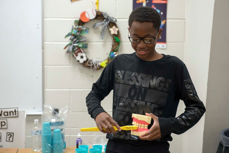 A middle school student from Holloman Middle School shows his brushing techniques on a fake set of teeth, Feb. 26, 2020, at Holloman Middle School on Holloman Air Force Base, N.M. On an annual-basis, the dental flight ensures to visit the Holloman Child Development Center, Holloman Elementary School
and Holloman Milddle School, providing them with knowledge on proper brushing techniques and the negative effects of not brushing teeth. (U.S. Air Force photo by Staff Sgt. Christine Groening)