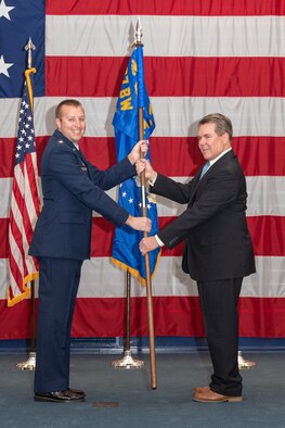 Photo of Greg Juneau taking flag