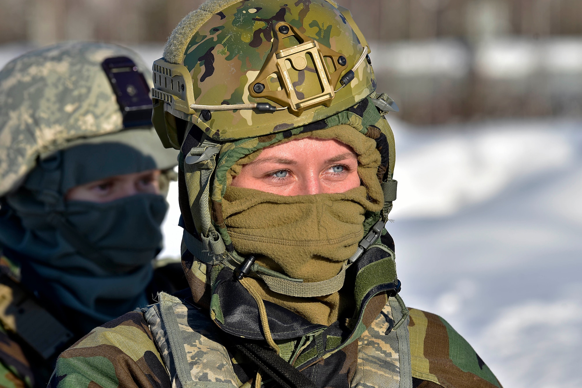 Senior Airman Sierra Warriner, 354th Security Forces Squadron installation entry controller, listens to a brief during a medical evacuation exercise on Eielson Air Force Base, Alaska, Feb. 26, 2020. Defenders donned cold-weather and mission oriented protective posture (MOPP) gear as part of the exercise. (U.S. Air Force photo by Senior Airman Beaux Hebert)