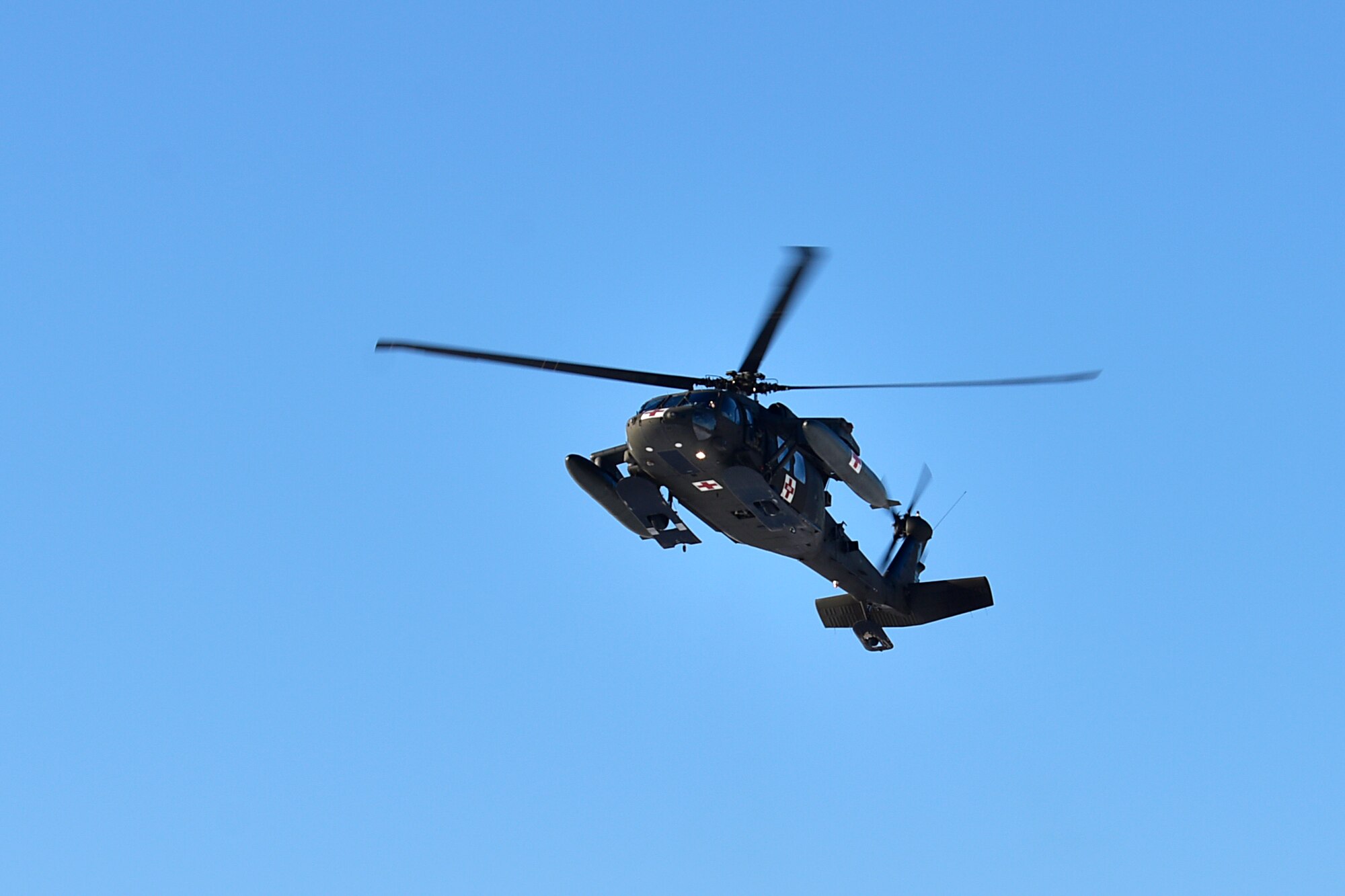 A UH-60 Blackhawk from 1-52D General Support Aviation Battalion flies over during a medical evacuation (MEDEVAC) exercise on Eielson Air Force Base, Alaska, Feb. 26, 2020. This particular Blackhawk is designed for MEDEVACs and is able to evacuate casualties in different austere environments. (U.S. Air Force photo by Senior Airman Beaux Hebert)