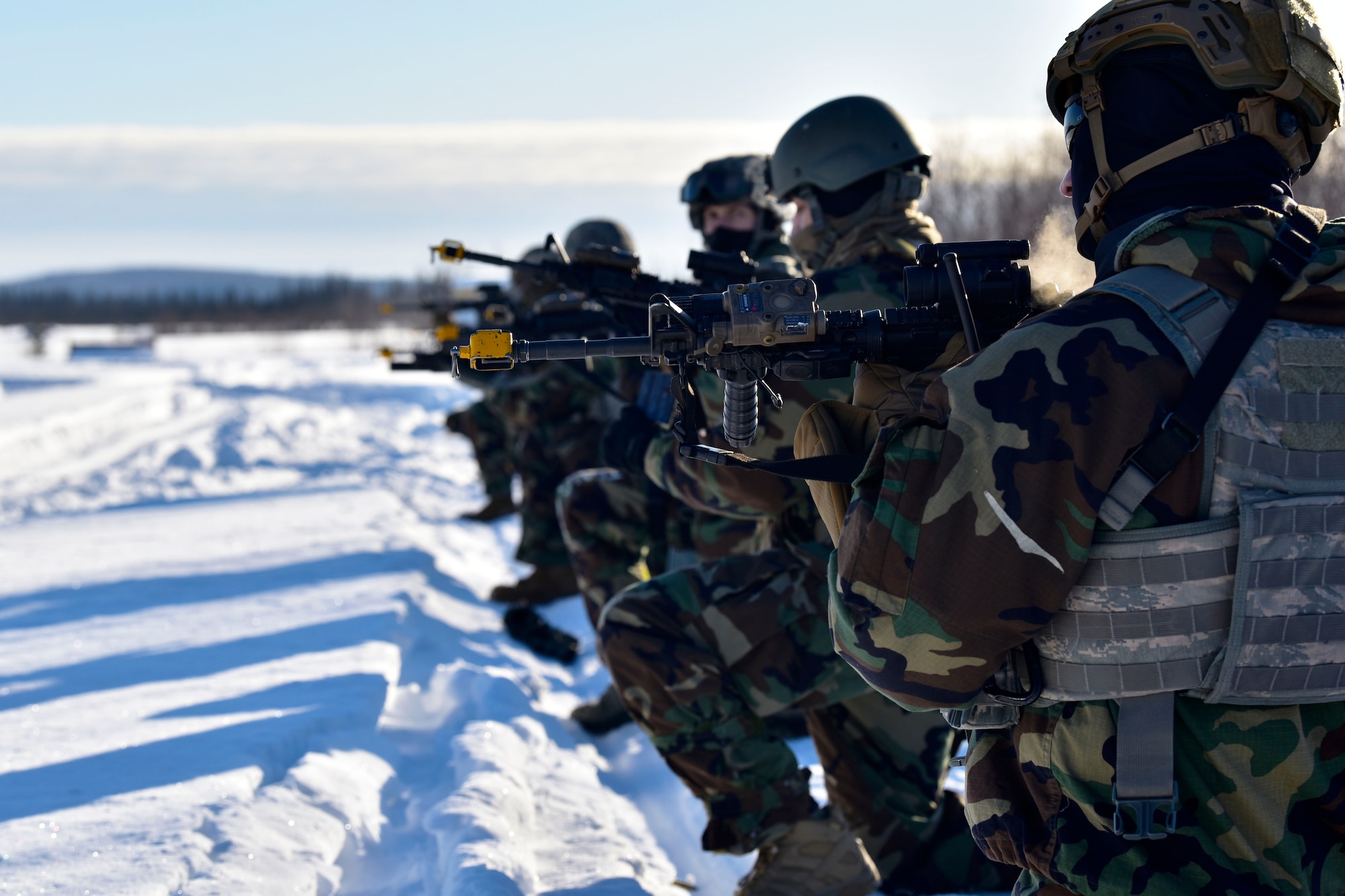 354th Security Forces Squadron defenders simulate an ambush during a medical evacuation exercise on Eielson Air Force Base, Alaska, Feb. 26, 2020. The defender’s M4 carbines are equipped with a blank-firing adaptor to simulate the sound of a gunshot without any projectiles. (U.S. Air Force photo by Senior Airman Beaux Hebert)