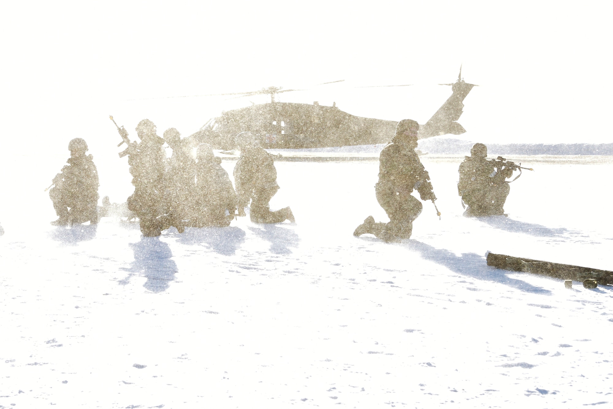 354th Security Forces Squadron defenders hold a perimeter around a simulated casualty while a UH-60 Blackhawk lands during a medical evacuation (MEDEVAC) exercise on Eielson Air Force Base, Alaska, Feb. 26, 2020. While waiting for the MEDEVAC, defenders must hold a perimeter around the casualty until help arrives. (U.S. Air Force photo by Senior Airman Beaux Hebert)