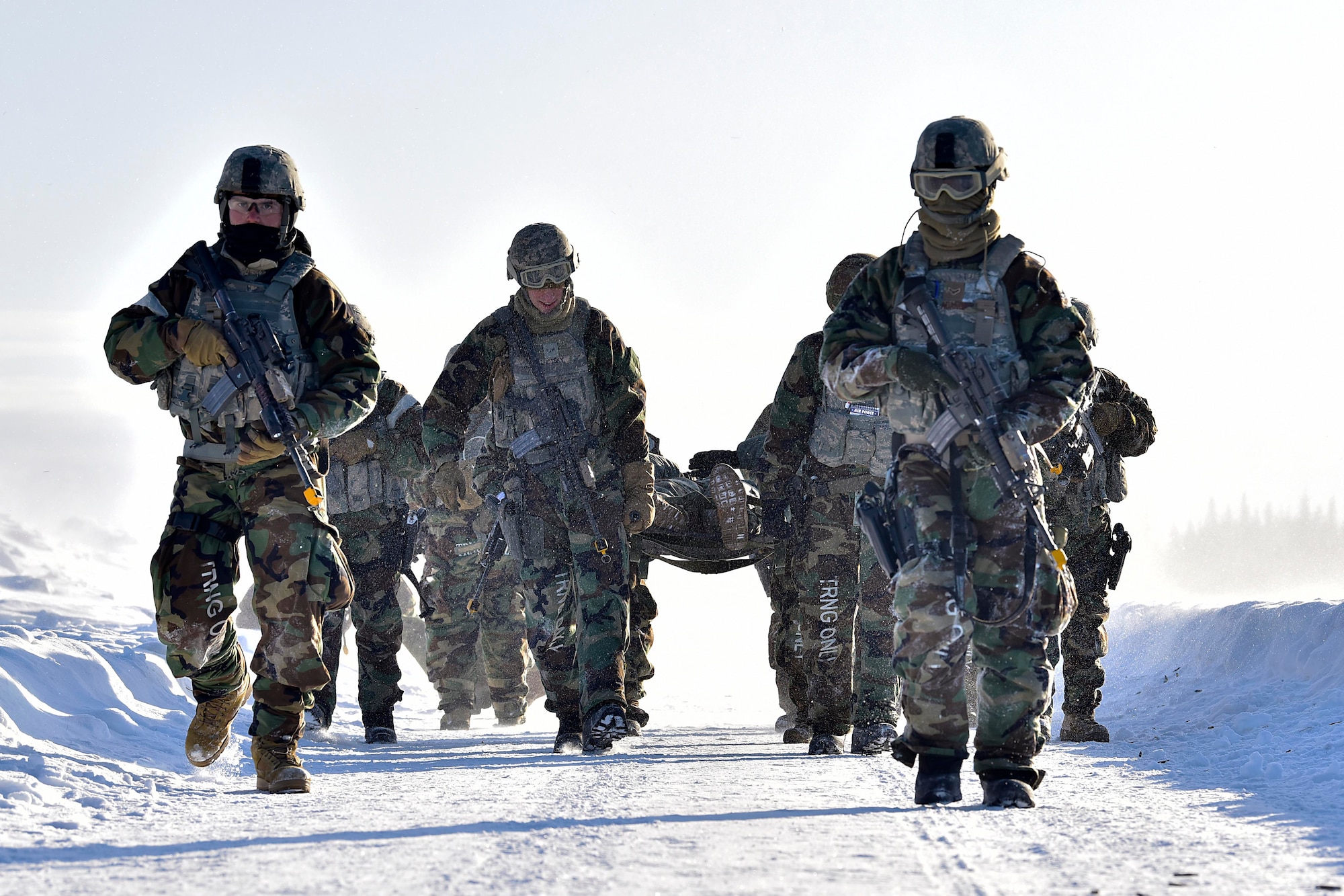 354th Security Forces Squadron defenders carry a simulated casualty during a medical evacuation exercise on Eielson Air Force Base, Alaska, Feb. 26, 2020. The defenders simulated taking small-arms fire and evacuating a casualty to a UH-60 Blackhawk assigned to the 1-52D General Support Aviation Battalion. (U.S. Air Force photo by Senior Airman Beaux Hebert)