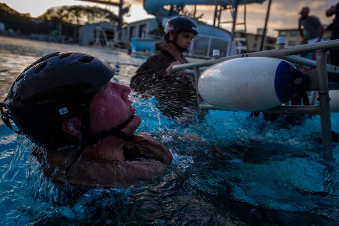 A U.S. Marine with Headquarters Battalion, Marine Corps Base Hawaii, escapes from a chair during Helicopter Underwater Egress Training, MCBH, Feb. 27, 2020. The training provides Marines with confidence to safely and efficiently exit a submerged aircraft in the event of a water landing. (U.S. Marine Corps photo by Cpl. Matthew Kirk)