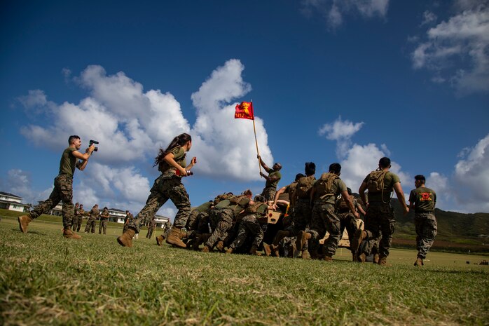 U.S. Marines with Headquarters Battery, 1st Battalion, 12th Marine Regiment push a High Mobility Multipurpose Wheeled Vehicle (HMMWV) during the St. Barbara’s day field meet, Marine Corps Base Hawaii, Feb. 27, 2020. The St. Barbara’s day field meet is an annual celebration in honor of St. Barbara, the patron saint of artillery, to build camaraderie and friendly competition within the unit. The celebration consists of relay races, a trebuchet competition, and a HMMWV push. (U.S. Marine Corps photo by Lance Cpl. Samantha Sanchez)