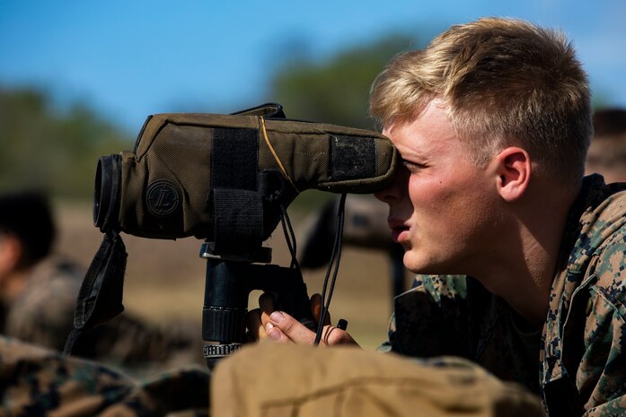 U.S. Marine Corps Lance Cpl. Ryan Lauritsen, assistant team leader, scout sniper platoon, Weapons Company, 3rd Battalion, 3rd Marine Regiment, observes a target during a joint training exercise, Pu’Uloa Range, Feb. 26, 2020. Special Reaction Team, Marine Corps Base Hawaii, and scout sniper platoon, conducted long range precision shooting to enhance marksman observer skill sets. (U.S. Marine Corps photo by Lance Cpl. Samantha Sanchez)