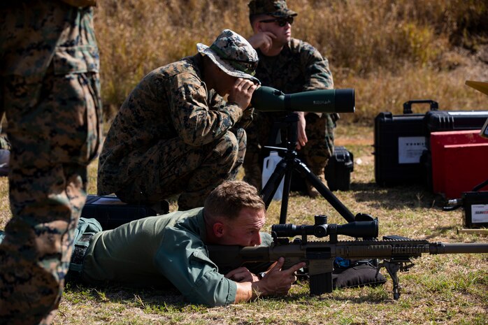 U.S. Marine Corps Cpl. Christopher Aldrich, entry team marksman observer, Special Reaction Team, Provost Marshal’s Office, Marine Corps Base Hawaii, prepares to fire during a joint training exercise, Pu’Uloa Range, Feb. 26, 2020. Special Reaction Team, Marine Corps Base Hawaii, and scout sniper platoon, Weapons Company, 3rd Battalion, 3rd Marine Regiment conducted long range precision shooting to enhance marksman observer skill sets. (U.S. Marine Corps photo by Lance Cpl. Samantha Sanchez)