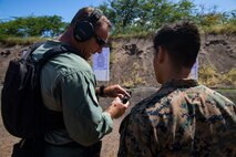 U.S. Marine Corps Lt. John Ivans, left, commander, Special Reaction Team, Provost Marshal’s Office, Marine Corps Base Hawaii, speaks to a Marine with scout sniper platoon, Weapons Company, 3rd Battalion, 3rd Marine Regiment during a joint training exercise, Pu’Uloa Range, Feb. 26, 2020. Special Reaction Team, Marine Corps Base Hawaii, and scout sniper platoon, conducted long range precision shooting to enhance marksman observer skill sets. (U.S. Marine Corps photo by Lance Cpl. Samantha Sanchez)