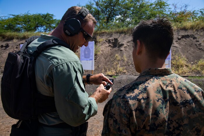 U.S. Marine Corps Lt. John Ivans, left, commander, Special Reaction Team, Provost Marshal’s Office, Marine Corps Base Hawaii, speaks to a Marine with scout sniper platoon, Weapons Company, 3rd Battalion, 3rd Marine Regiment during a joint training exercise, Pu’Uloa Range, Feb. 26, 2020. Special Reaction Team, Marine Corps Base Hawaii, and scout sniper platoon, conducted long range precision shooting to enhance marksman observer skill sets. (U.S. Marine Corps photo by Lance Cpl. Samantha Sanchez)