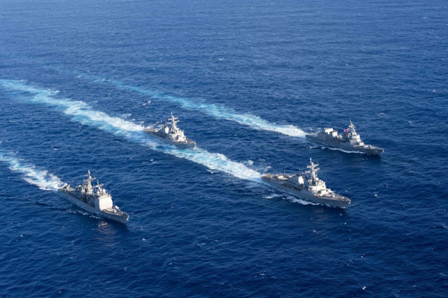 Official U.S. Navy file photo of U.S. Navy ships and Japan Maritime Self-Defense Force ships sailing in formation.