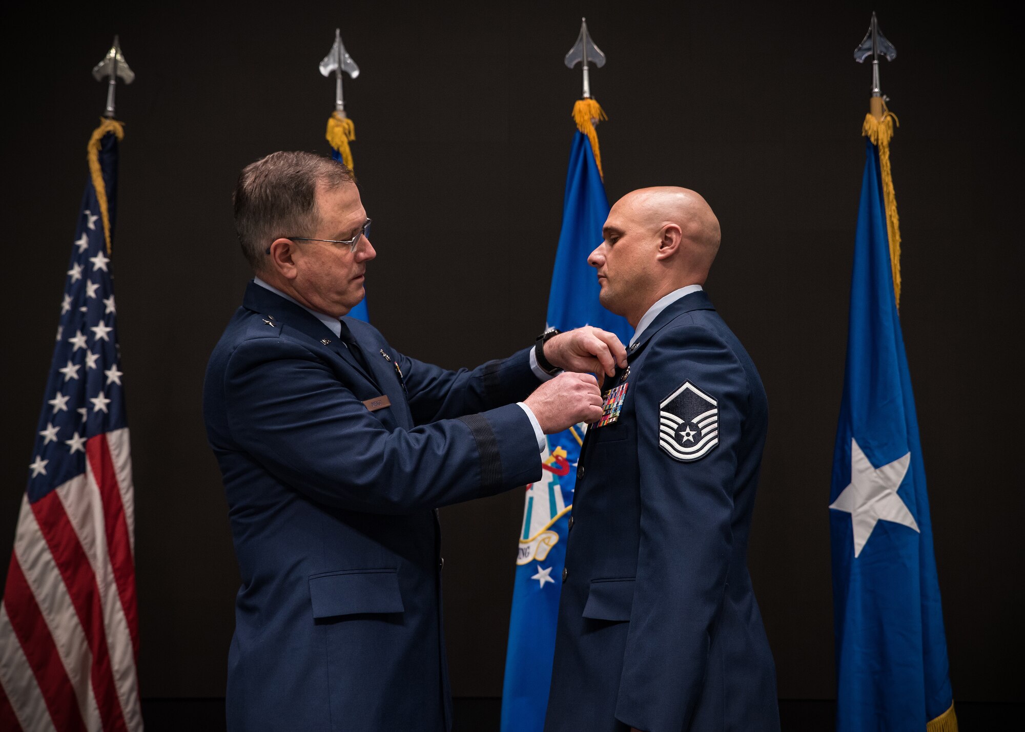 The Bronze Star was presented to Master Sgt. Timothy L. Heggedahl, an intelligence analyst, by Brig. Gen. James Dienst, commander of the Air Force Research Laboratory’s 711th Human Performance Wing, during a ceremony at the Air Force Institute of Technology, Wright-Patterson Air Force Base, on Feb. 26, 2020. Heggedahl was awarded the Bronze Star Medal by Lt. Gen. Joseph Guastella, U.S. Air Forces Central Command. Heggedahl distinguished himself by meritorious achievement while engaged in military operations in Iraq from Nov. 18, 2018, to June 25, 2019. (U.S. Air Force photo/Richard Eldridge)