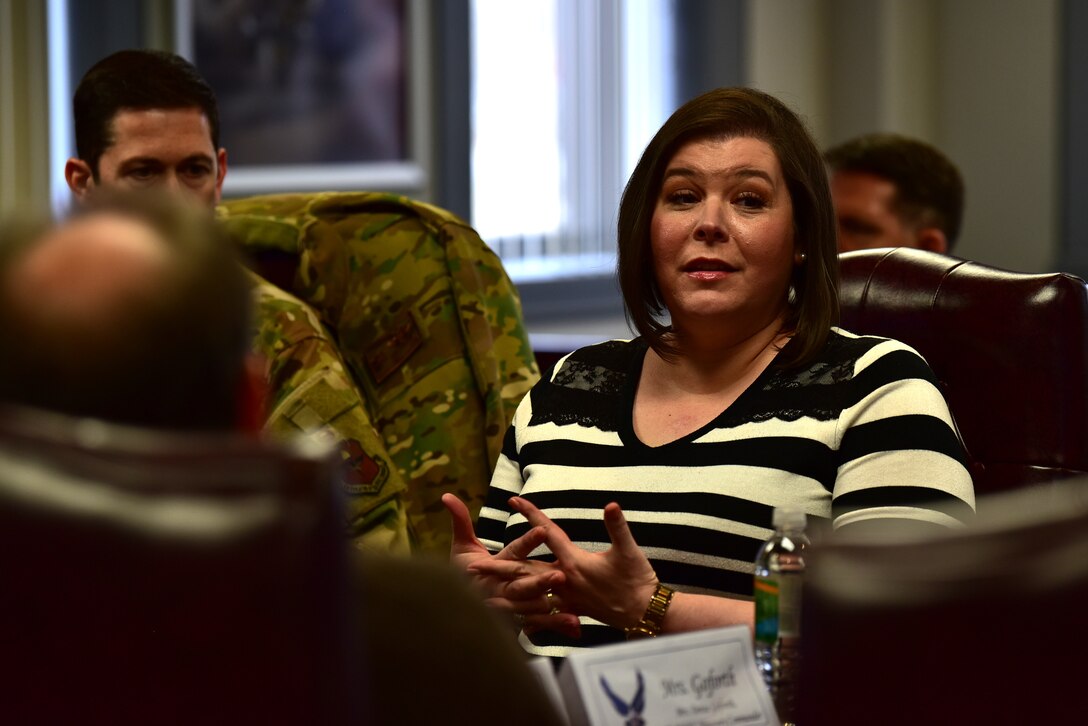 people discuss while sitting a t a large conference table