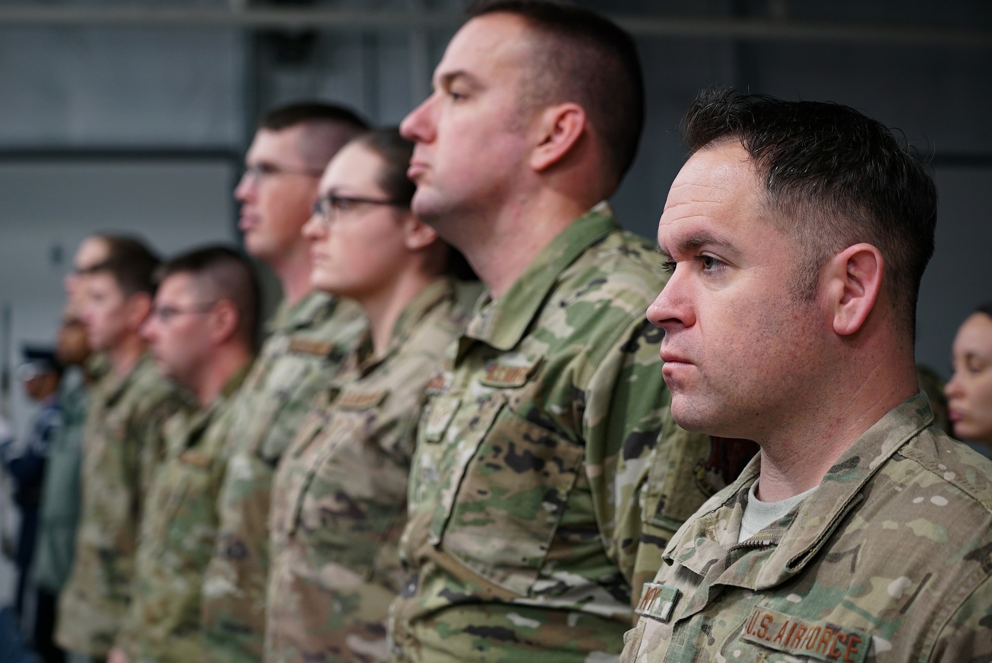 Members of the 319th Security Forces Squadron stand at attention during the presentation of colors Dec. 20, 2019, during a memorial ceremony on Grand Forks Air Force Base, North Dakota. The ceremony was held in memory of military working dog “Dex,” who served as a narcotic detector dog with his most recent handler, Staff Sgt. Sean King, 319th Security Forces Squadron.  (U.S. Air Force photo by Senior Airman Elora J. Martinez)