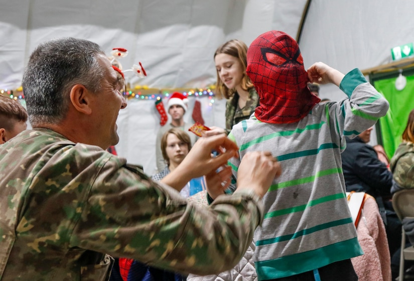 NATO Soldiers give local children holiday cheer during “Operation Christmas”