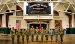 Members of the 112th Engineer Battalion with their organizational colors on the drill floor of the Cleveland Grays Armory Museum Aug. 7, 2019, in downtown Cleveland. Members of the 112th Engineer Battalion staff took a tour of the 1893 armory to learn about the history of the Cleveland Grays, an organization whose lineage the battalion perpetuates.