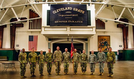 Members of the 112th Engineer Battalion with their organizational colors on the drill floor of the Cleveland Grays Armory Museum Aug. 7, 2019, in downtown Cleveland. Members of the 112th Engineer Battalion staff took a tour of the 1893 armory to learn about the history of the Cleveland Grays, an organization whose lineage the battalion perpetuates.