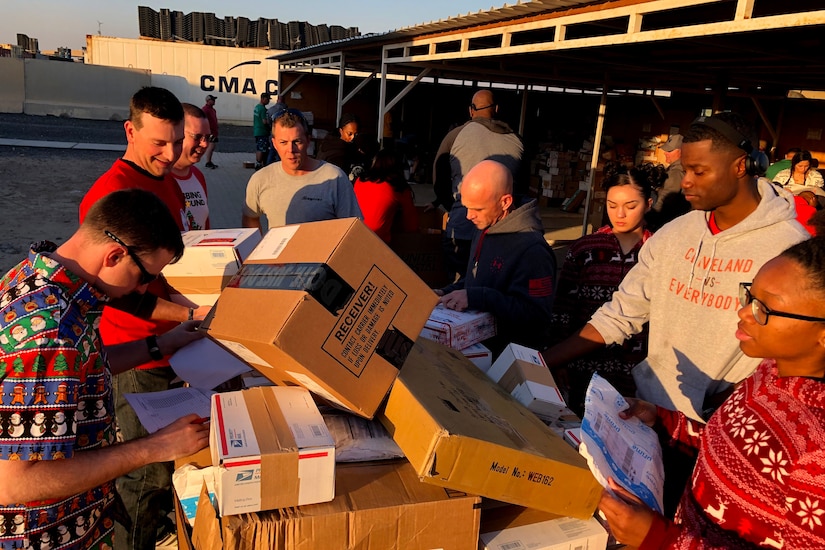 U.S. Soldiers who serve as mail clerks in the 30th Armored Brigade Combat Team, sort and load packages at the Camp Buehring post office in Kuwait on Christmas Day, Dec. 25, 2019. The unit is comprised of more than 4,000 Citizen-Soldiers from the North Carolina, South Carolina, Ohio and West Virginia National Guard deployed to the Middle East to support Operation Spartan Shield.  (U.S. Army National Guard photo by Lt. Col. Cindi King)