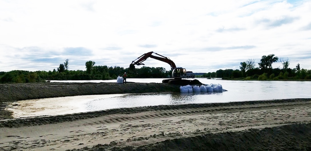Flood fighting efforts are taken Sept. 22 to protect completed repair efforts from rising high water along the L-575 Missouri River Levee System where initial breach repairs were being made.