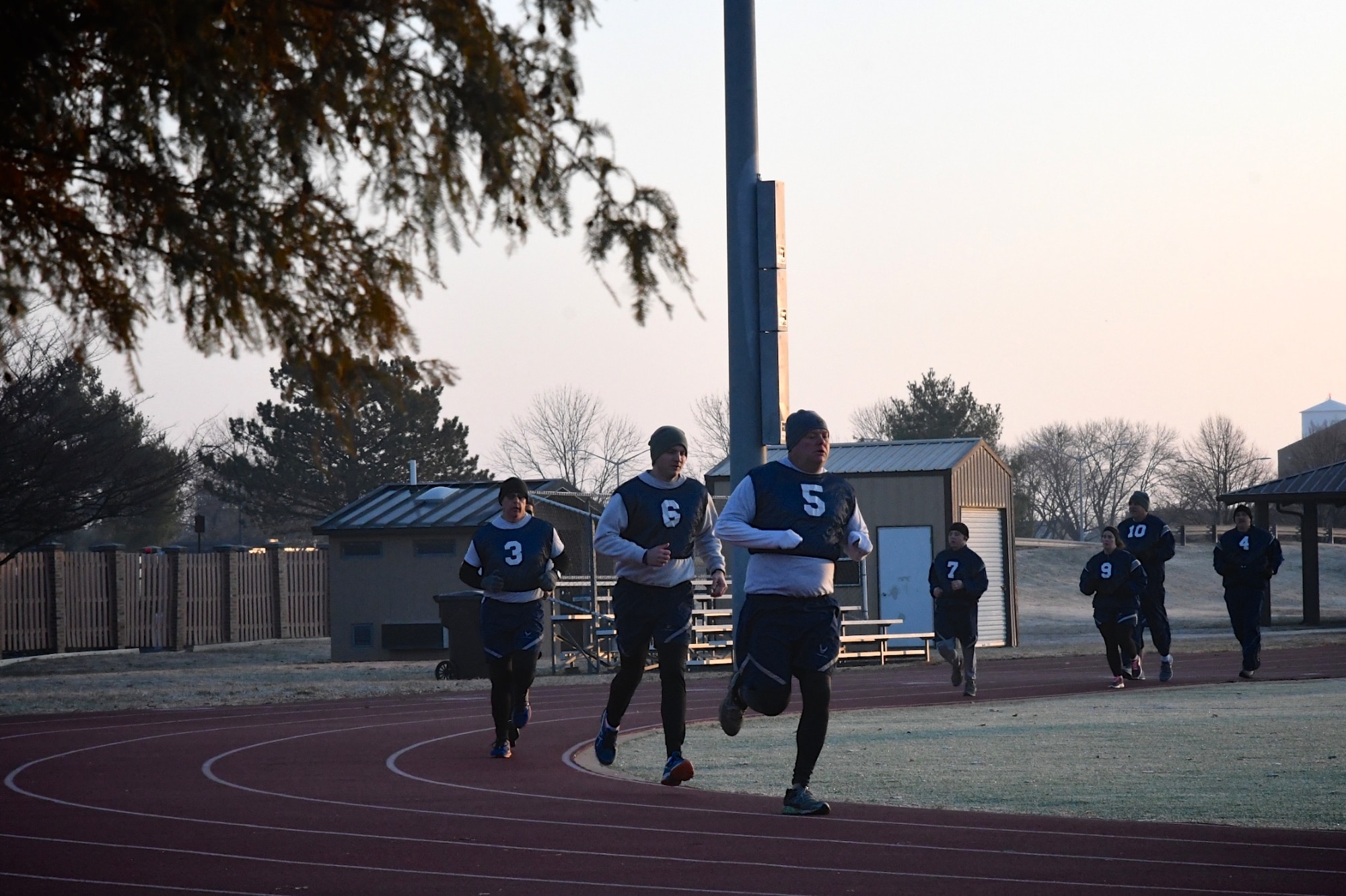 Airmen of the Air Force Reserve Command complete another 400 meter lap, number four of six recently achieved.  932nd Airlift Wing Citizen Airmen reservists perform the 1.5 mile run as part of the Air Force fitness assessment recently at Scott Air Force Base, Illinois. The weather was a bit chilly at 6:30 a.m., but winds were calm and pleasantly warm once the sun rose Nov. 16, 2019. Reservists from more than 30 states come to train each month at the Illinois unit known among reserve units as the "Gateway Wing" due to its proximity to the Saint Louis arch. Fitness test also include pushups, sit-ups and height and weight measurements. Staying fit throughout the year helps keep Airmen ready for any future challenges.  (U.S. Air Force photo by Lt. Coi. Stan Paregien)