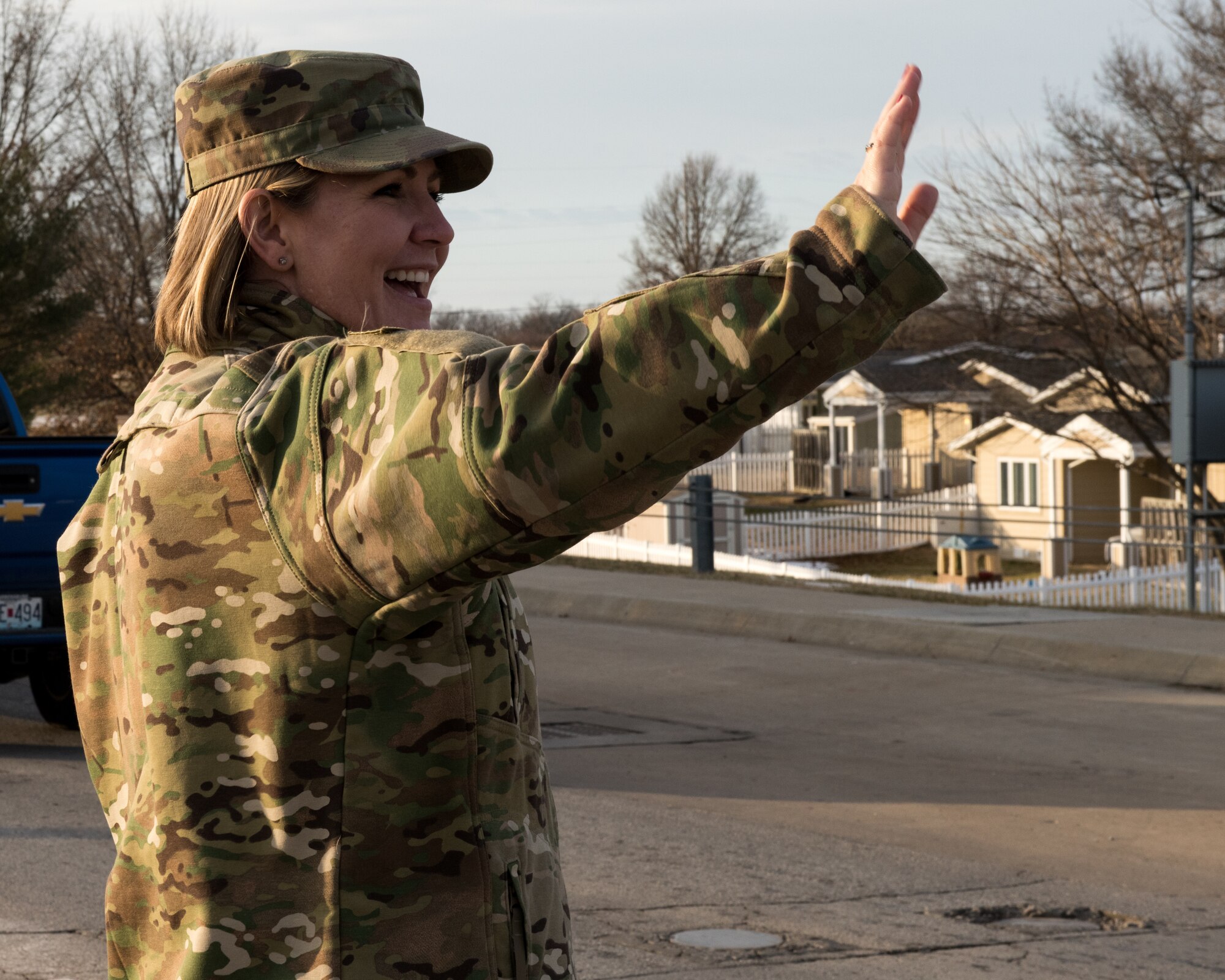 U.S. Air Force Chief Master Sgt. Kathleen McCool, 509th Bomb Wing command chief, waves to Airmen as they leave the base on Dec. 20, 2019, at Whitman Air Force Base, Missouri. McCool and other chief master sergeants took the opportunity to strengthen connections by handing out candy canes and wishing Whiteman Airmen and families a happy holiday. (U.S. Air Force photo by Airman 1st Class Christina Carter)