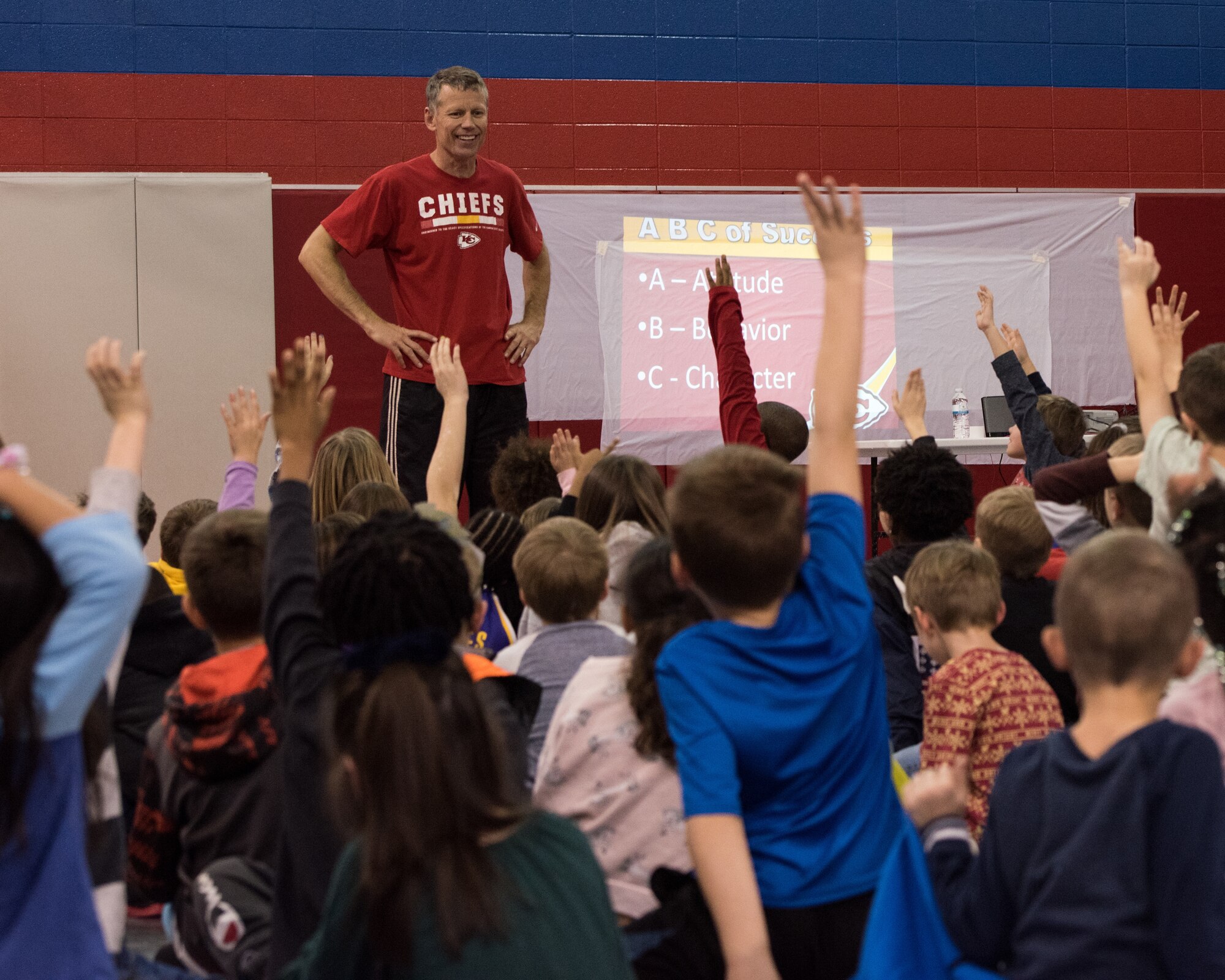 Dan Meers, the Kansas City Chiefs NFL team mascot KC Wolf, visited the Youth Center at Whiteman Air Force Base, Missouri, Dec. 18, 2019. Meers talked to the children about the importance of your attitude, behavior and character and answered questions about what life is like as a mascot as part of an outreach to positively influence their overall well-being and promote resiliency. (U.S. Air Force photo by Airman 1st Class Christina Carter)