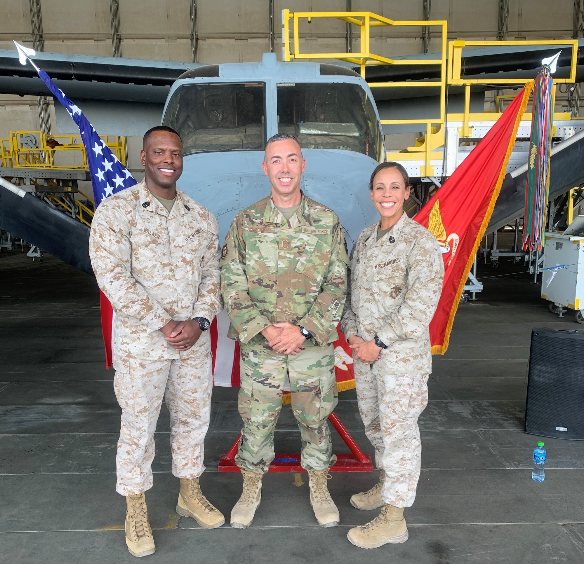 Marine First Sergeant Percy E. Walker, U.S. Marine Corps, Special Purpose Marine Air-Ground Task Force – Crisis Response – Central Command, left; Senior Master Sgt. John V. McDonald, 407th Expeditionary Support Squadron first sergeant; and First Sergeant Angela J. Lopez, USMC, SPMAGTF-CR-CC, pose in front of a MV-22 Osprey display during the United States Marine Corps 244th Birthday Ceremony at Ahmed Al Jaber Air Base, Kuwait, Nov. 7, 2019. On Nov. 10, 1775, the Continental Marines were established. (Courtesy photo)
