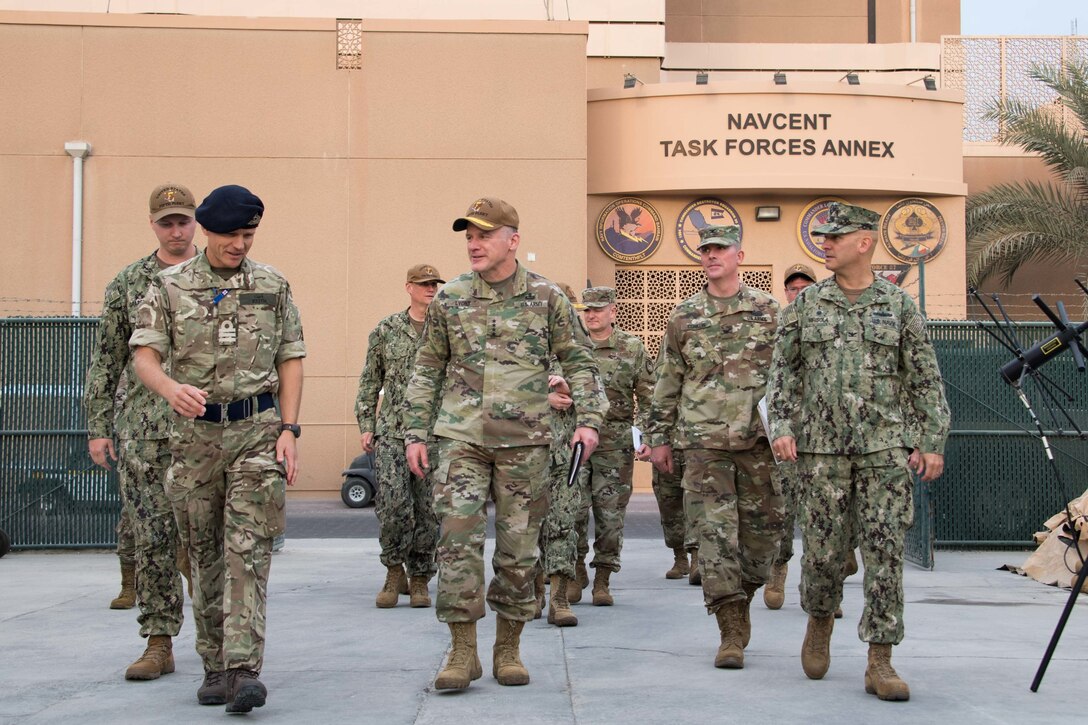 U.S. Army Gen. Stephen R. Lyons, center, commander of U.S. Transportation Command, receives a mission overview from Royal Navy Cmdr. Ben Keith while walking to the International Maritime Security Construct where the Coalition Task Force Sentinel operates, during his visit to U.S. Naval Forces Central Command Nov. 15.