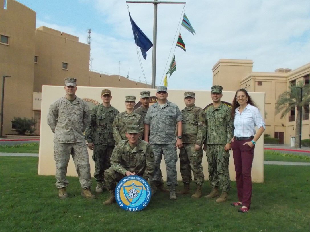 U.S. Army Reserve Col. John Conklin, center, and active and reserve Soldiers, Sailors, Marines, and Airmen and a DoD civilian from the Joint Planning Support Element, pose for a group photo in front of the Combined Maritime Forces Headquarters, Naval Support Activity, Bahrain.