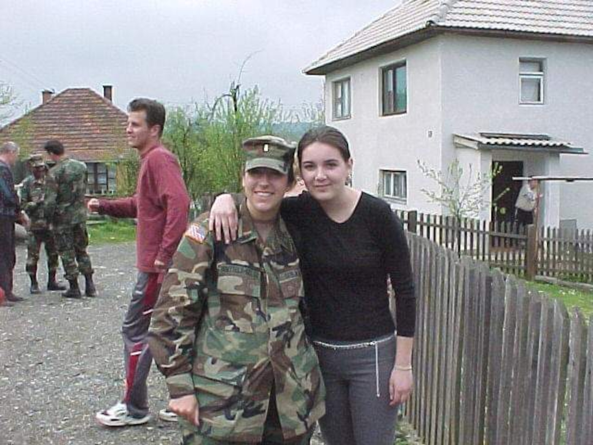 Now-Air Force Lt. Col. Elizabeth Hoettels, 423rd Medical Squadron commander, poses for a photo during a deployment in Bosnia with one of the locals, Samra, during her prior career as an Army Civil Affairs officer. Hoettels served 10 years in the Army before transitioning to the Air Force. (Courtesy photo)
